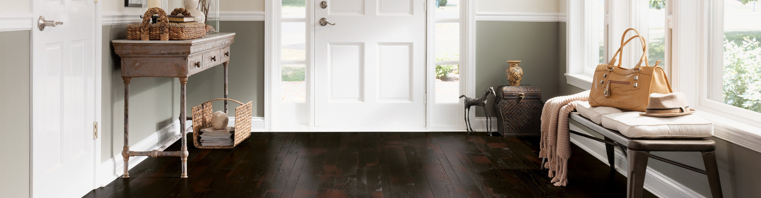 dark hardwood flooring in entryway hallway near front door